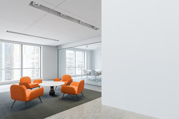 Waiting room with orange armchairs in office