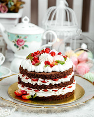 chocolate cake with whipped cream and fruits