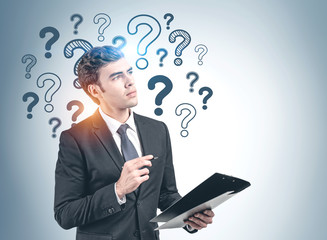 Man with clipboard and question marks