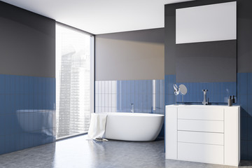 Fototapeta na wymiar Gray and blue tile bathroom corner, tub and sink
