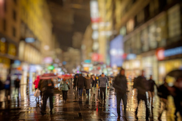 silhouette of colorful people on the rainy night street