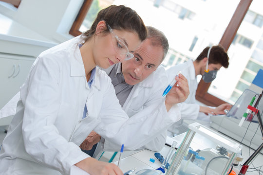 attractive young female scientist and her senior male supervisor