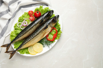Tasty smoked fish on light grey marble table, top view. Space for text