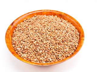 Buckwheat groats in bamboo bowl on white background. Weight loss concept