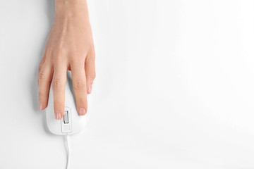 Woman using modern wired optical mouse on white background, top view