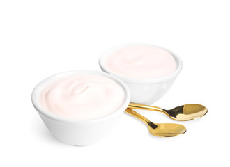 Tasty organic yogurt in bowls and spoons isolated on white