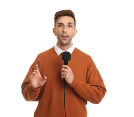 Young male journalist with microphone on white background