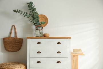 Chest of drawers in stylish room interior
