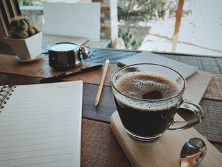 cup of coffee on wooden table in cafe