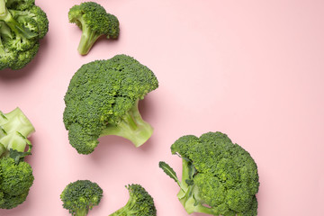Fresh broccoli on pink background, flat lay. Space for text
