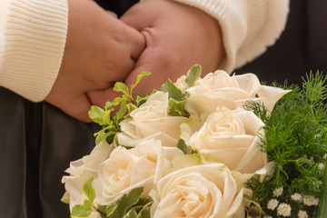 Obraz na płótnie Canvas Bridal Bouquet on Blurred Child's Hands Background