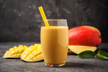 Fresh delicious mango drink on grey table