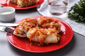 Delicious cabbage rolls served on grey table