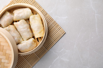 Delicious cabbage rolls served on light grey marble table, top view. Space for text