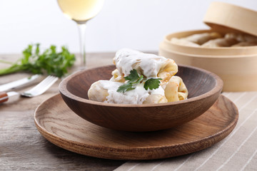 Delicious cabbage rolls served on wooden table