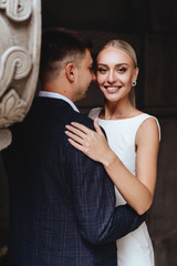 Happy bride and groom near old castle in wedding day