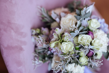 Rich bunch of pink peonies and lilac eustoma roses flowers, green leaf in glass vase. Fresh spring bouquet. Summer Background