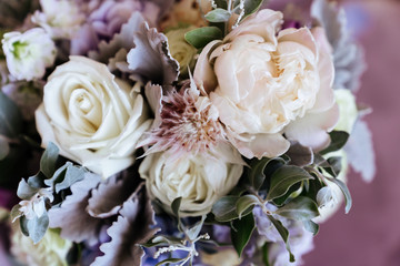 Rich bunch of pink peonies and lilac eustoma roses flowers, green leaf in glass vase. Fresh spring bouquet. Summer Background