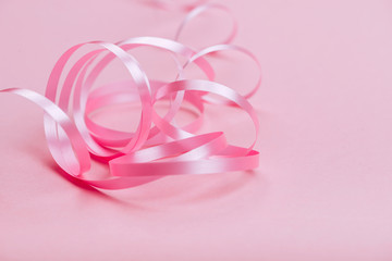 beautiful pink ribbon on bright background copy space