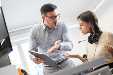 Two business colleagues having disagreement and conflict in office