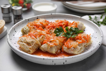 Delicious cabbage rolls served on grey table, closeup