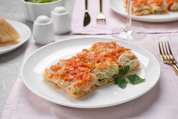 Delicious cabbage rolls served on grey table