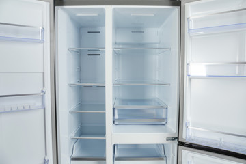 Shelves of empty modern refrigerator, closeup view
