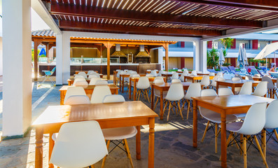 open-air restaurant in resort Greek hotel, wooden roof,