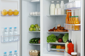 Fototapeta na wymiar Open refrigerator full of different fresh products