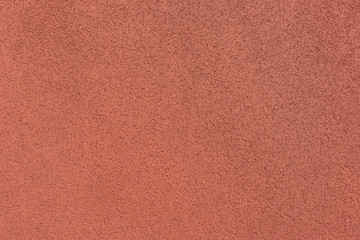 The plastered wall in terracotta color. Vintage background.