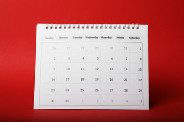 Paper calendar on red background. Planning concept