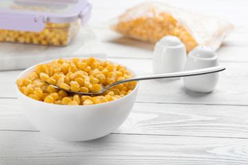 Frozen sweet corn on white wooden table. Vegetable preservation