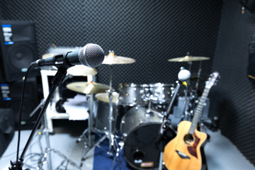 Professional condenser studio microphone, Musical Concept. recording, selective focus  microphone in radio studio, selective focus microphone and blur musical equipment guitar ,bass,