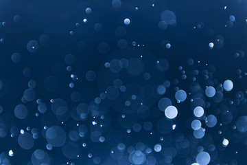 abstract sparkle bokeh light effect with navy blue background