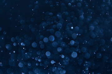 abstract sparkle bokeh light effect with navy blue background