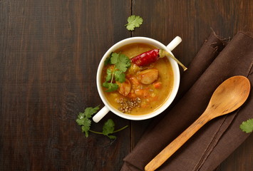 Dal, red lentil soup with turmeric, garlic, chili and cilantro. Indian food, top view, copy space