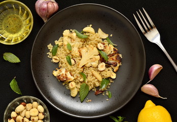 Baked cauliflower, quinoa and hazelnut salad, top view 