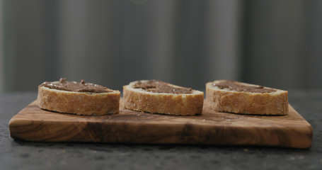 ciabatta slice with chocolate nut butter on olive board