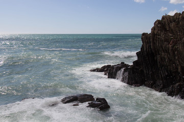 Seascape landscape. Horizon line above sea. Waves crashing on rocks.
