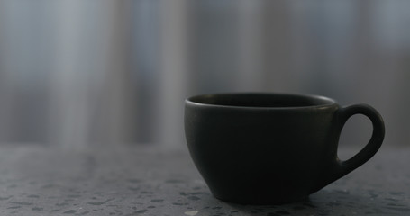 Obraz na płótnie Canvas empty black cup on terrazzo countertop