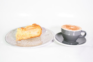 Charlotte of pears and cappuccino on a white background