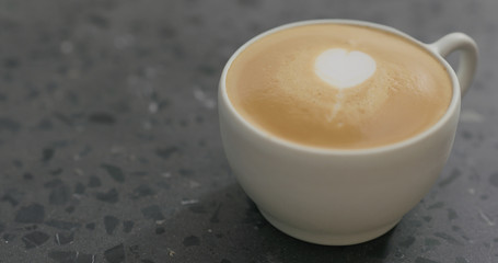 cappuccino in white cup on terrazzo countertop