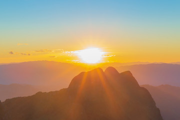 Panorama photo of Sunset or evening time with blue sky and sunray or sunbeam at Doi Luang Chiang Dao, Chaingmai, Thailand.