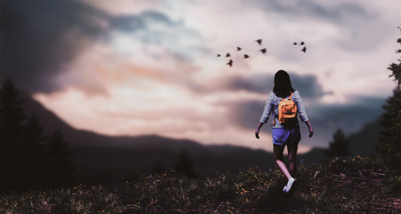 a girl walking alone on mountain edge background sunset background.
