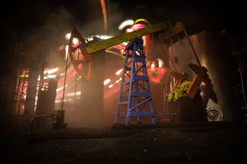 Artwork decoration. Oil pump and oil rig energy industrial machines for petroleum at night with fog...