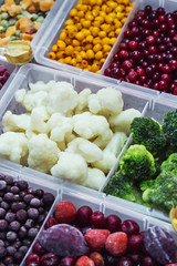 frozen vegetables, fruits and berries in the shop window