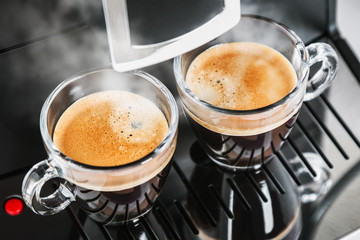glass cups with freshly brewed coffee from the coffee machine