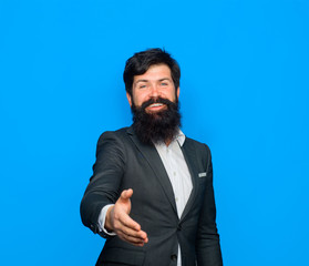 Smiling businessman going to handshake. Successful business. Handshake concept. Businessman giving hand to welcome. Businessman in suit. Greeting visitor. Welcome business.