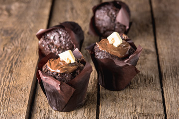 Four Tasty Chocolate Muffins on Old Wooden Background Tasty Homemade Cupcake Dessert Horizontal Copy Space