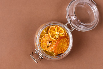 Jar of Tasty Homemade Citrus Chips Brown Background Healthy Diet Food Top View Horizontal